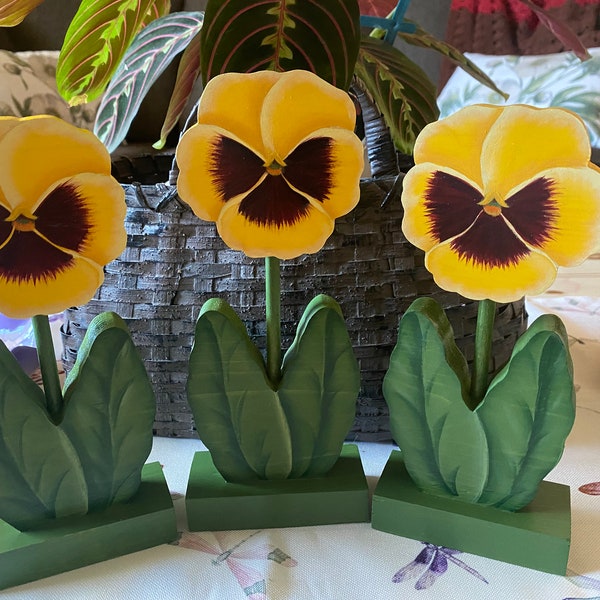 Wooden hand painted yellow pansies. Ready for spring to summer decorating. Each pansy is painted on both sides. They are sold in a set of 3.