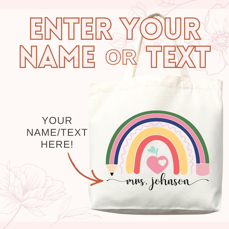 May include: A white canvas tote bag with a colorful rainbow design. The rainbow includes red, yellow, green, and blue arches, with a pink heart and apple. Text on the bag reads "ENTER YOUR NAME OR TEXT" and "YOUR NAME/TEXT HERE!"