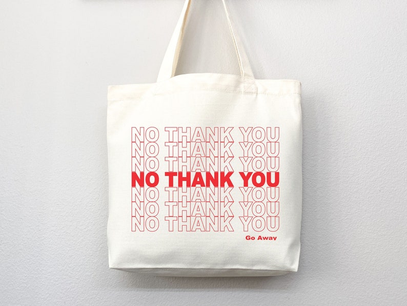 May include: Off-white canvas tote bag with red text that reads "NO THANK YOU" repeated multiple times. The words "NO THANK YOU" are in a bold red font. The phrase "Go Away" is printed at the bottom in red.