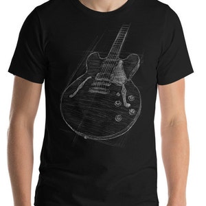 May include: A black t-shirt with a white sketch of an electric guitar on the front.