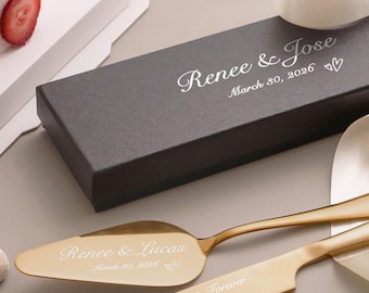 May include: A gold-toned cake knife and server set with engraved text. The server features the text "Renee & Lucas March 30, 2026" with a heart icon. The knife is engraved with "Always & Forever". A black rectangular box displays "Renee & Jose March 30, 2026".
