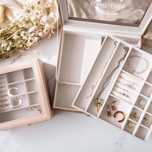 a couple of jewelry boxes sitting on top of a table