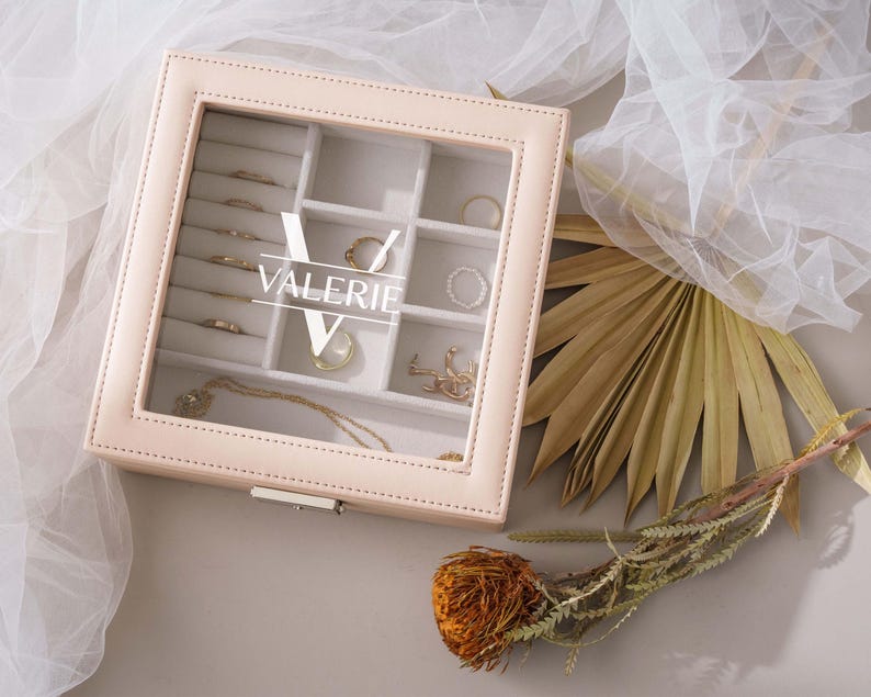 a white box with a bunch of jewelry inside of it