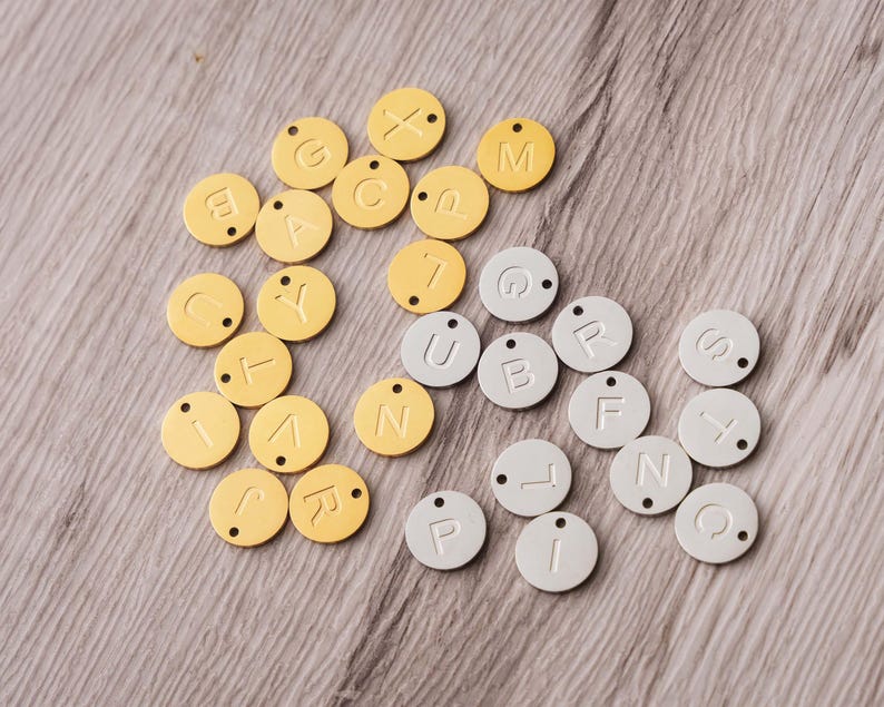 a pile of yellow and white name tags on a table