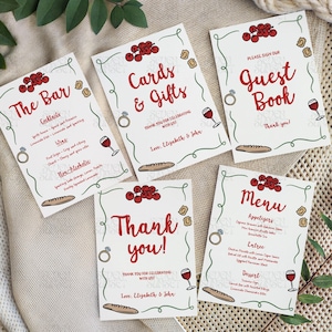 May include: Five white wedding signs with red text and illustrations. The signs read "The Bar", "Cards & Gifts", "Guest Book", "Thank You!", and "Menu". Each sign has a border, ring, wine glass, and bread illustration.