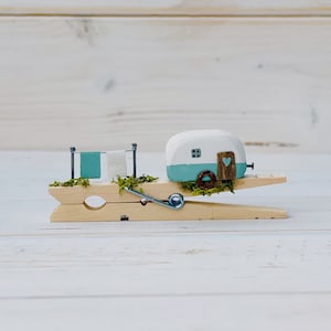Home is where we park it. Clothes peg caravan. Driftwood scene.