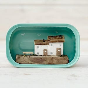 Sardine Tin Cottages. Driftwood scene.