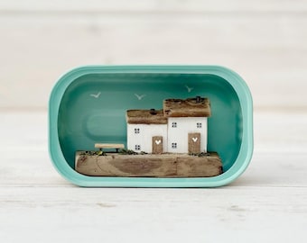 Sardine Tin Cottages. Driftwood scene.