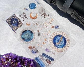 May include: A sheet of clear, transparent stickers with a celestial theme. The stickers feature a variety of images, including a crescent moon, a clock face with stars, a book, a crystal ball, and a bottle with a cork. The stickers are perfect for adding a touch of magic to your planner, journal, or scrapbook.