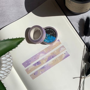 May include: Three rolls of washi tape with a purple, pink, and beige background. The tape features a moon, stars, and clouds design. The tape is labeled "Washi Tape - 15mm x 5m - Mini"