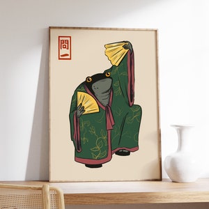 May include: A digital illustration of a frog wearing a green and gold robe with a red sash and holding two fans. The frog is standing on a beige background with the Japanese character "開" in red in the top left corner.