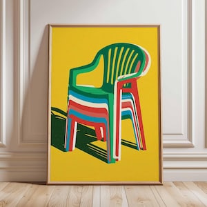 May include: A framed art print featuring a stack of colorful plastic chairs against a bright yellow background. The chairs are depicted in shades of green, red, blue, and white, creating a vibrant and modern aesthetic. The artwork is displayed in a room with white wainscoting and a wooden floor.