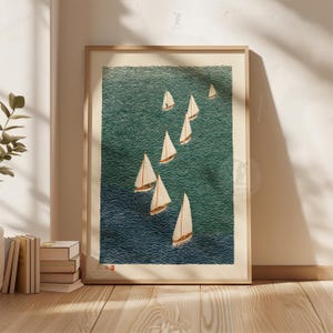 May include: A framed print featuring a fleet of sailboats on a textured teal and navy blue ocean. The sailboats have white sails and brown hulls. The artwork is displayed in a light wood frame.