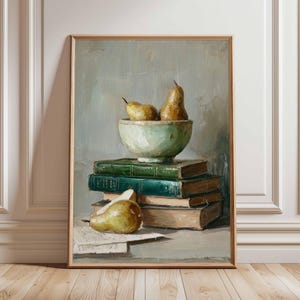 May include: A framed still life painting depicting pears in a green bowl on a stack of books. The pears are yellow-green, and the books are green and tan. A single pear rests on paper in the foreground. The background is a muted grey.