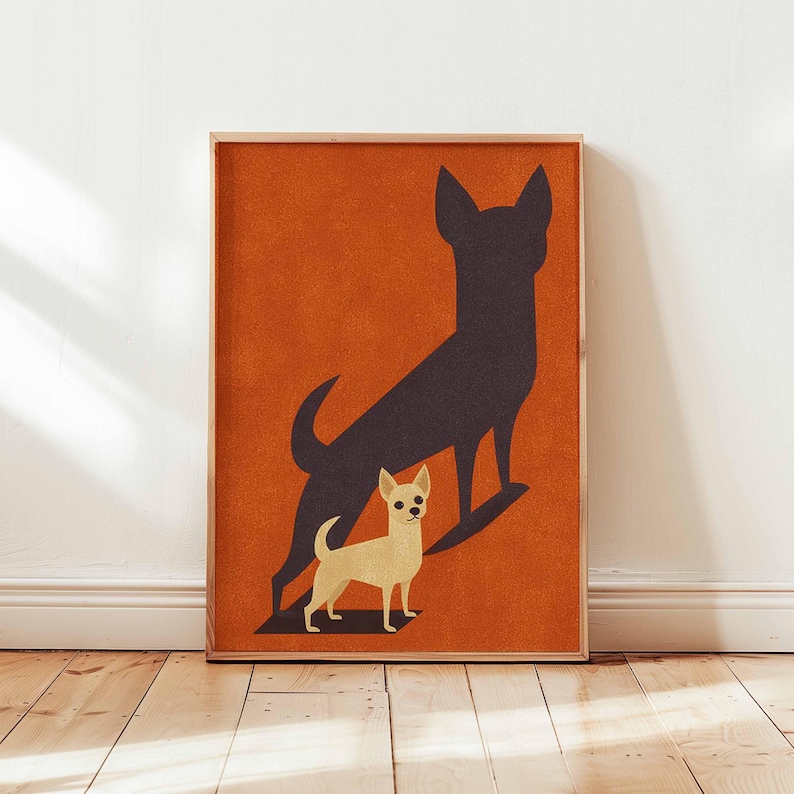 May include: A framed art print featuring a tan Chihuahua with a dark brown shadow against an orange background. The artwork has a minimalist design, with the dog's silhouette and shadow creating a striking visual contrast. The frame is made of wood.