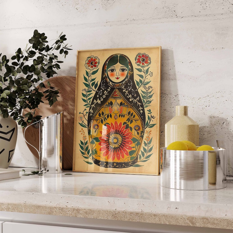 May include: A vintage-style print of a Russian nesting doll, or matryoshka doll, with a colourful floral design. The doll is depicted with a black dress and a red flower on her chest. The background is a light yellow with green leaves and flowers.
