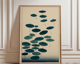 May include: A framed print featuring a collection of teal and dark blue parasols against a cream-colored background. The parasols are depicted in a stylized, artistic manner, with a gradient effect. The artwork is framed in a light brown wooden frame.