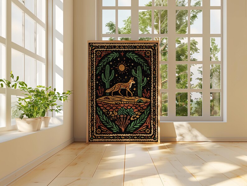 May include: A framed art print featuring a desert landscape with a fox, cacti, and sun. The artwork has a black background with orange, green, and yellow accents. The print is displayed in a bright room with a window.