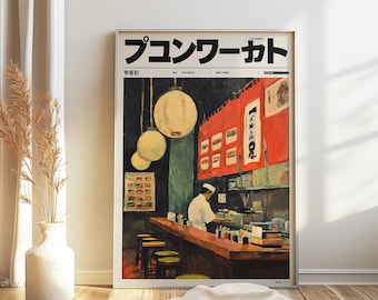May include: Framed print of a Japanese restaurant interior. The artwork features a chef behind a wooden counter, with hanging lanterns and red curtains. The print has Japanese text at the top.