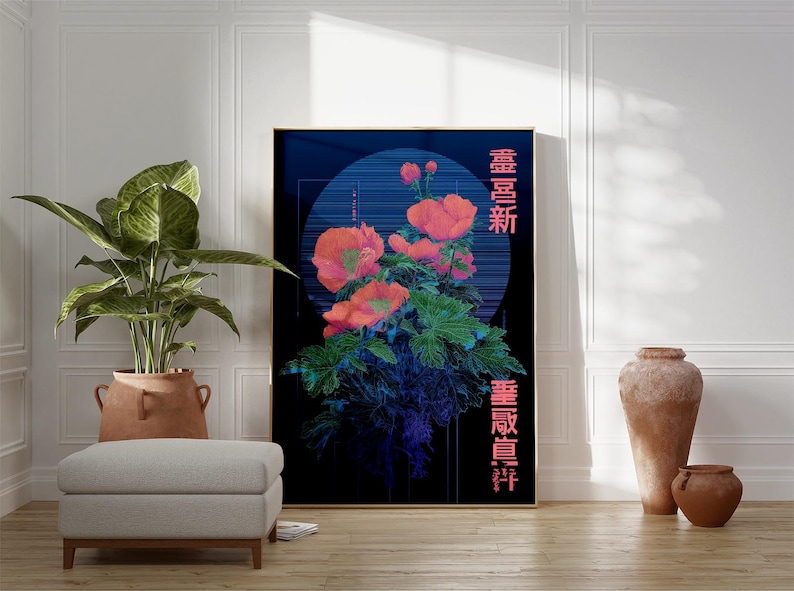 May include: A framed art print featuring a floral design with orange flowers and green leaves against a dark blue background. Japanese characters are printed in pink. The artwork is displayed in a room with a plant and a footstool.