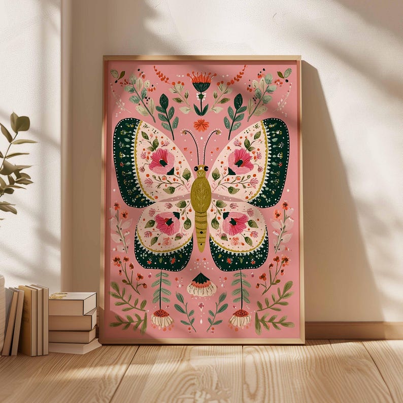 May include: A framed art print featuring a detailed illustration of a butterfly with floral patterns. The butterfly has pink, green, and cream-colored wings, set against a pink background. The artwork is surrounded by botanical elements.