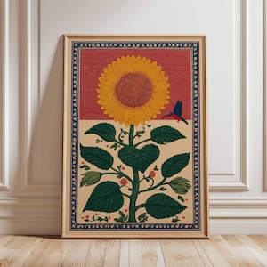 May include: A framed art print featuring a stylized sunflower with a large yellow bloom and a red and tan background. A blue bird is perched near the flower. The print has a dark blue border and is set in a wooden frame.