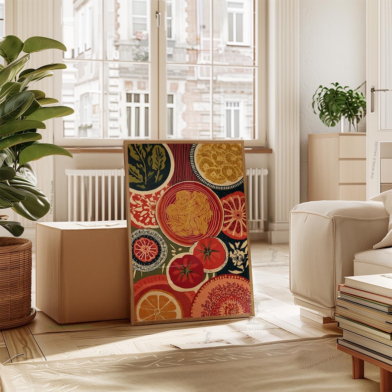 May include: A framed art print featuring a colorful, stylized illustration of food items. The artwork includes images of pasta, tomatoes, oranges, and decorative circular patterns in shades of red, orange, green, and yellow.