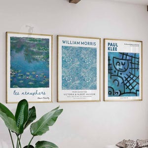 May include: Three framed art prints with gold frames. The prints feature artwork by Claude Monet, William Morris, and Paul Klee. The Monet print depicts water lilies, the Morris print has a floral pattern, and the Klee print has abstract figures.