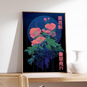 May include: A framed art print featuring a floral design with coral-colored flowers and green leaves against a dark blue background. Japanese characters are printed vertically on the right side of the artwork. A white vase sits on a wooden surface.