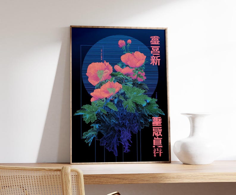 May include: A framed art print featuring a floral design with coral-colored flowers and green leaves against a dark blue background. Japanese characters are printed vertically on the right side of the artwork. A white vase sits on a wooden surface.