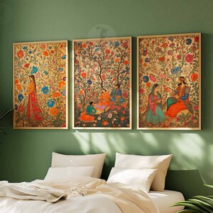 May include: Three framed prints with intricate floral designs and figures in traditional clothing. The prints feature vibrant colors and detailed artwork, depicting scenes from a Mughal garden.