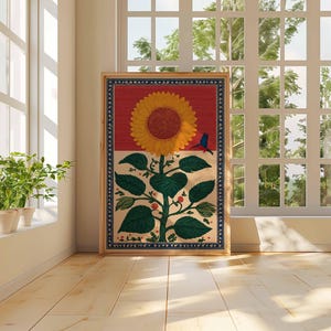 May include: A framed artwork featuring a large yellow sunflower with green leaves and red berries. A small blue bird is perched on the flower. The background is divided into red and cream sections, with a blue patterned border.