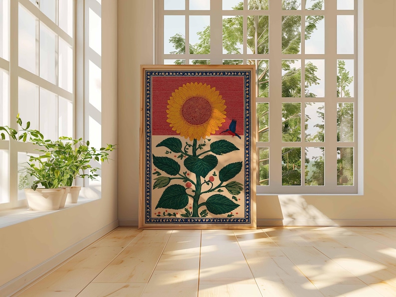 May include: A framed artwork featuring a large yellow sunflower with green leaves and red berries. A small blue bird is perched on the flower. The background is divided into red and cream sections, with a blue patterned border.