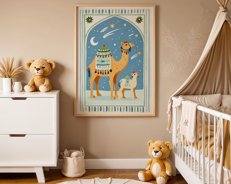 May include: A framed art print featuring a camel and calf under a starry night sky. The artwork has a blue and green arched background with a crescent moon and stars. The camels are tan with decorative saddles. The print is in a light wood frame.