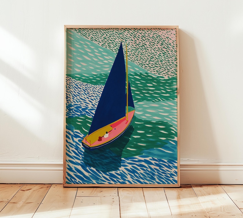 May include: A framed art print depicting a sailboat on water. The boat has a navy blue sail, a pink hull, and a yellow mast. The water is shown in shades of blue and green, with a textured pattern. The artwork is presented in a wooden frame.