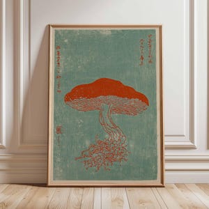 May include: Framed art print featuring a stylized illustration of a mushroom in shades of orange and red against a teal background. The print includes Japanese text and is displayed in a wooden frame.