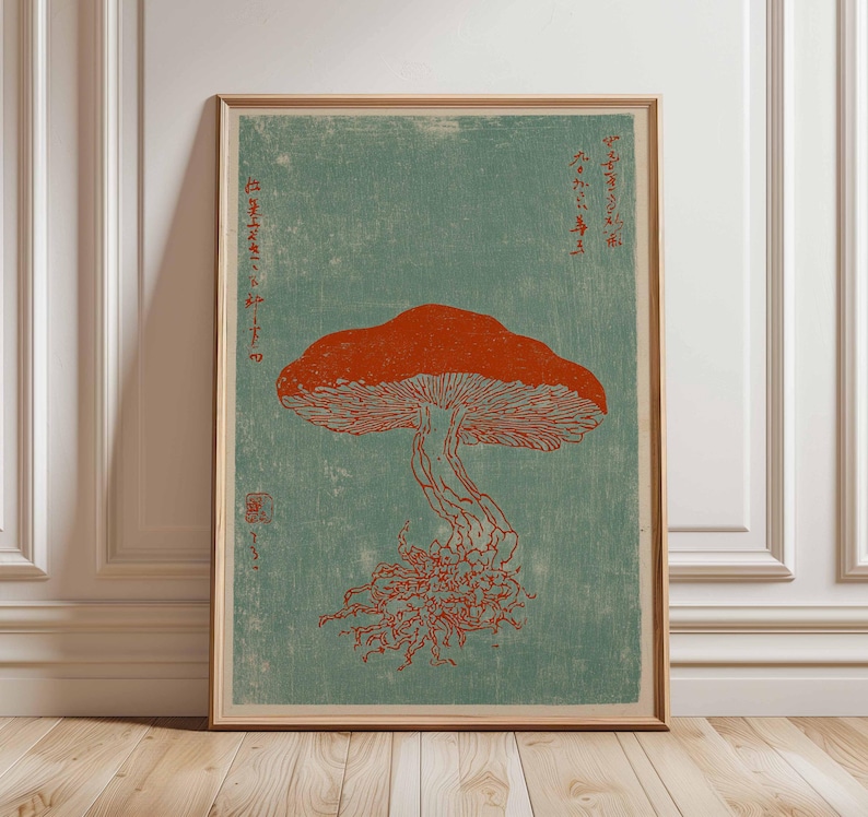 May include: Framed art print featuring a stylized illustration of a mushroom in shades of orange and red against a teal background. The print includes Japanese text and is displayed in a wooden frame.
