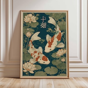 May include: Framed art print featuring two koi fish swimming in a pond with lily pads and lotus flowers. The fish have white, orange, and black markings. The background is a dark teal color with Japanese characters.