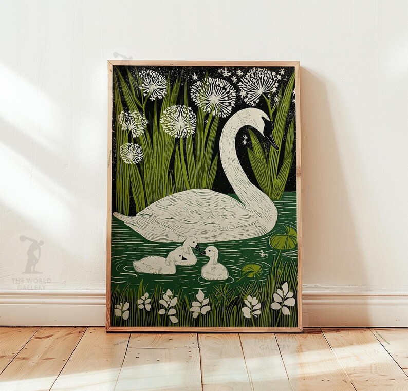 May include: A framed art print featuring a white swan with three cygnets in a pond. The artwork has a green and black background with stylized plants and flowers. The print is in a wooden frame.