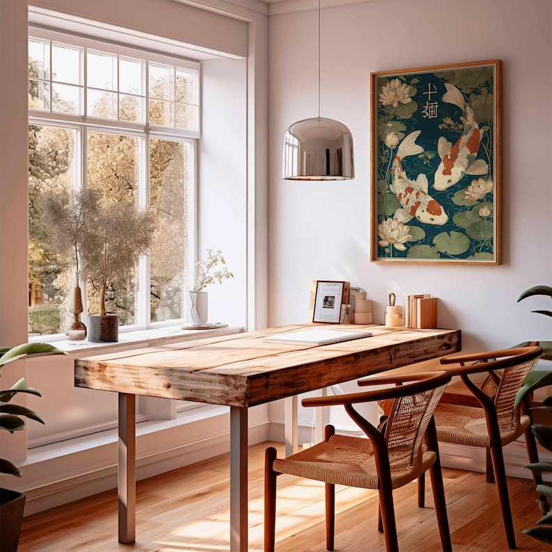 May include: A room with a wooden desk and two chairs. A framed artwork of koi fish swimming in a pond hangs on the wall. A large window provides natural light, and a silver pendant light hangs above the desk.