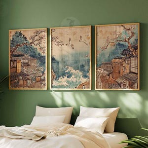 May include: Three framed prints of Japanese-style artwork depicting buildings, trees, and water. The prints are in a gold frame and have a vintage aesthetic.