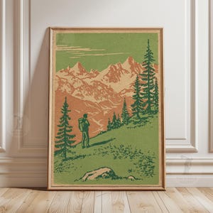 May include: Framed vintage print depicting a hiker in a mountainous landscape. The artwork shows a person with a backpack on a green hillside, with orange and white mountains in the background. The sky is green, and the trees are dark green.