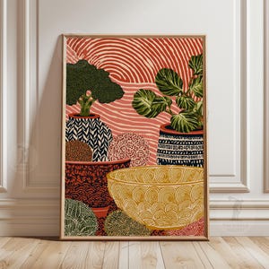 May include: A framed art print depicting a still life with potted plants and decorative bowls. The artwork uses a warm colour palette with red, yellow, and green hues. The background has a striped pattern, and the pots have intricate designs.