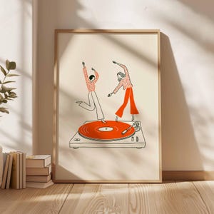 Puede incluir: Una impresi&oacute;n art&iacute;stica enmarcada con una ilustraci&oacute;n minimalista de dos figuras bailando sobre un tocadiscos. El tocadiscos tiene un disco naranja. Los bailarines llevan trajes rojos y blancos. El fondo es de un beige neutro.