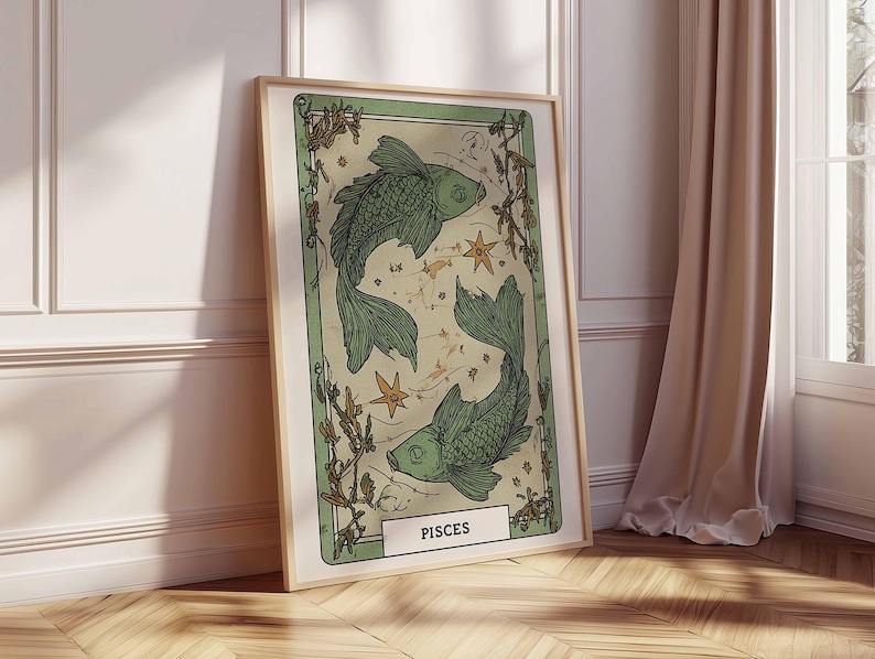 May include: A framed art print featuring a green illustration of two fish, representing the Pisces zodiac sign. The artwork has a vintage aesthetic with botanical elements and star details. The print is in a light wooden frame.