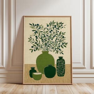 May include: A framed art print depicting a still life of olive branches in green vases. The artwork shows a large central vase with a full arrangement, surrounded by smaller vases in varying shades of green. The background is a neutral beige.
