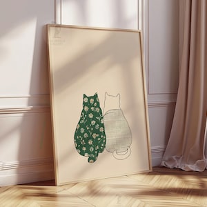 Puede incluir: Impresi&oacute;n art&iacute;stica enmarcada con dos gatos estilizados. Uno tiene un patr&oacute;n floral verde, el otro un dise&ntilde;o texturizado y claro. La obra est&aacute; sobre un fondo neutro, con un marco de madera.