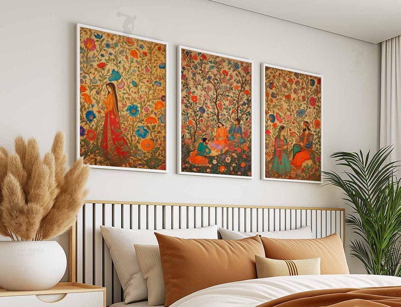 May include: Three framed prints with colorful floral patterns and figures in traditional Indian clothing. The prints are hung on a white wall above a bed with brown bedding.