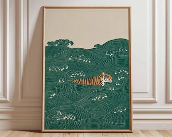 May include: Framed art print featuring a tiger swimming in stylized green waves. The tiger has orange and black stripes. The background is a light beige color. The artwork is in a wooden frame and is displayed on a wooden floor.