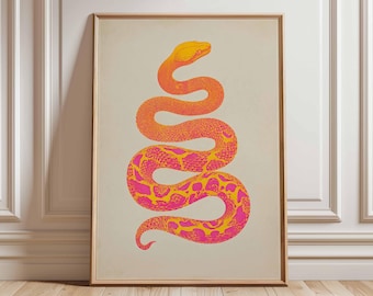 May include: A framed art print featuring a stylized snake illustration. The snake is depicted in vibrant colors, with a gradient of orange and yellow on the upper body and a pattern of pink and yellow on the lower body. The artwork is set against a neutral background.